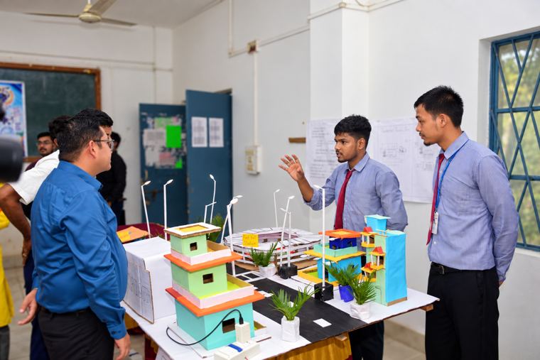 Students explain their smart city layout, complete with a football stadium