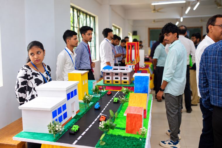 Civil engineering model of a planned road corridor, with a suspension bridge behind